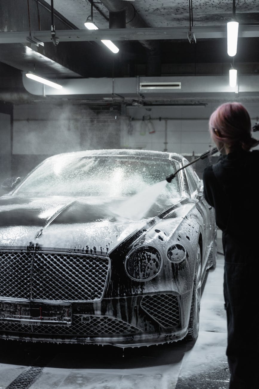 Car being washed in a professional detailing bay